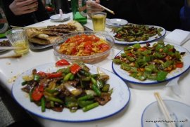 A table high in food in a Xinjiang restaurant.