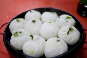 Steaming, piping hot dumplings fresh from a street meals merchant in Beijing, China.