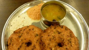 Vada served with sambar and coconut chutney.
